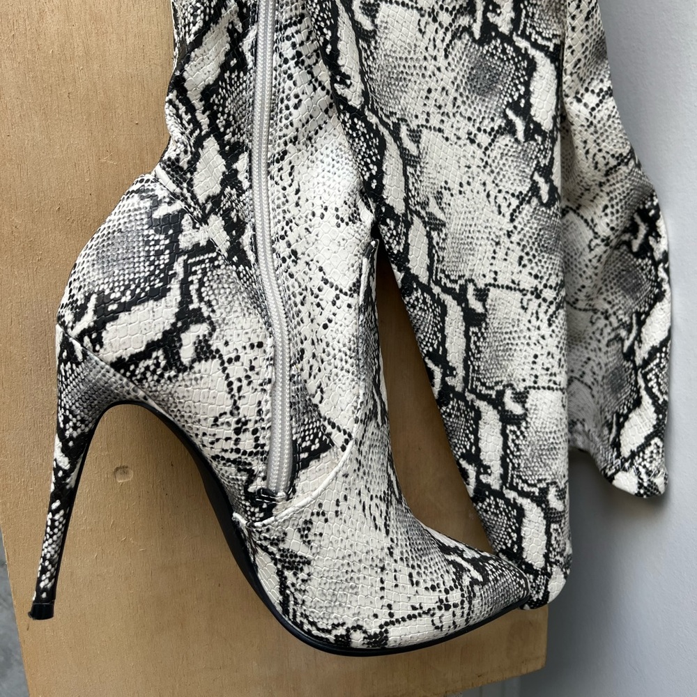 Thigh high soft boots snake skin look by Dominique. Like new worn once!